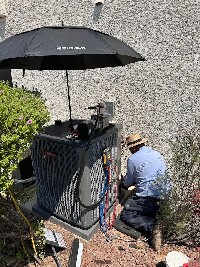HVAC technician performing outdoor AC maintenance in Old Tappan